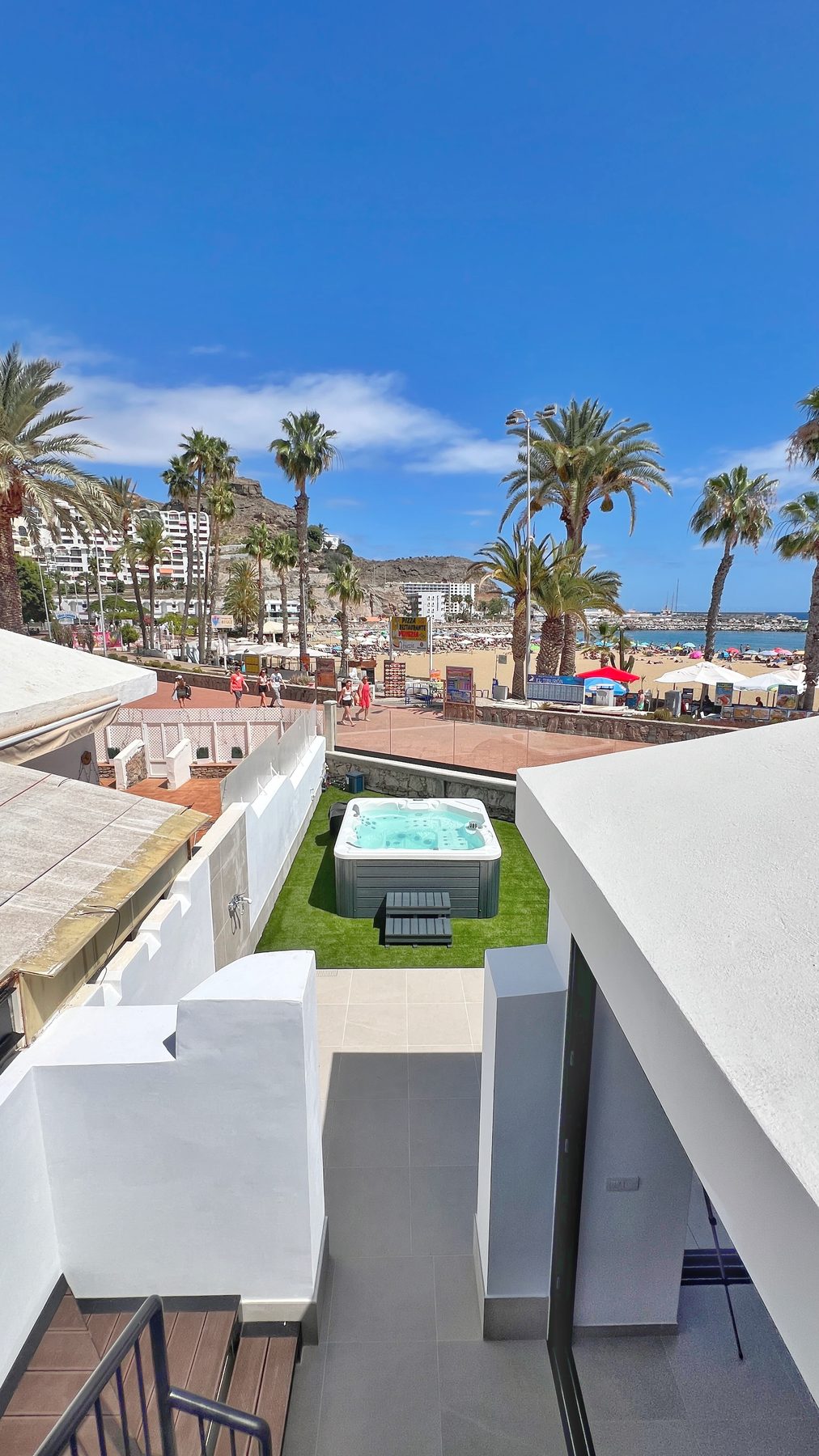 View over the jacuzzi to the beach and marina
