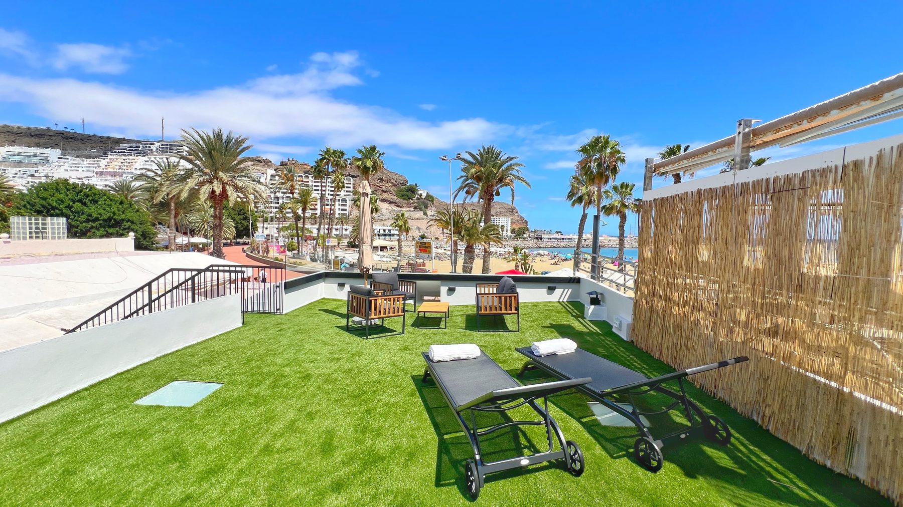 Rooftop solarium with loungers and sea views